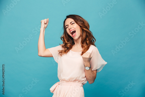 Excited young lady standing isolated photo