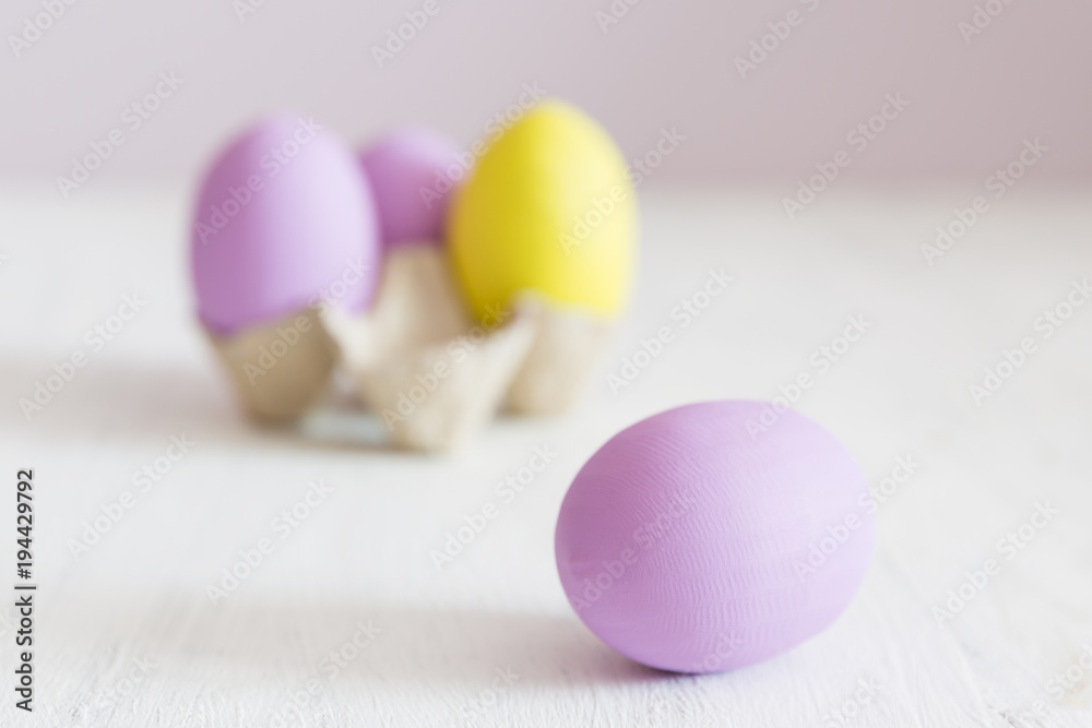 Easter postcard. Violet and yellow Easter eggs on a white vintage background. Copy space.