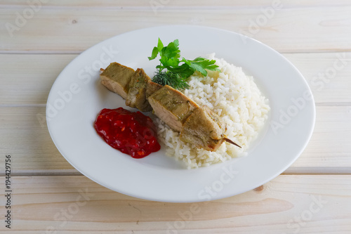 Pork shaslyk with rice and tomato sauce