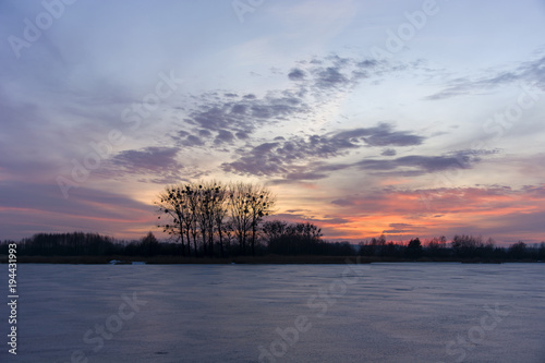 Pink sunset over a frozen lake