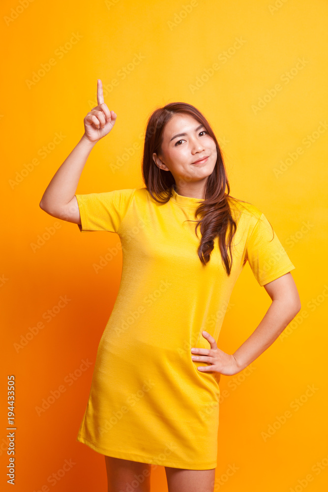 Young Asian woman smile and point up. Young Asian woman smile and point up.