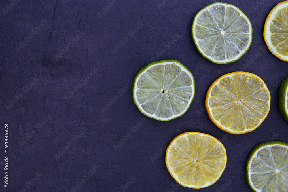 Lemon lime slices food on dark background Lemon lime slices food on dark background