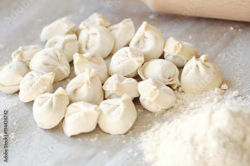 Homemade dumplings and flour on the table