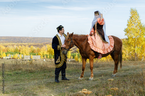 Татарская девушка на коне и татарин photo