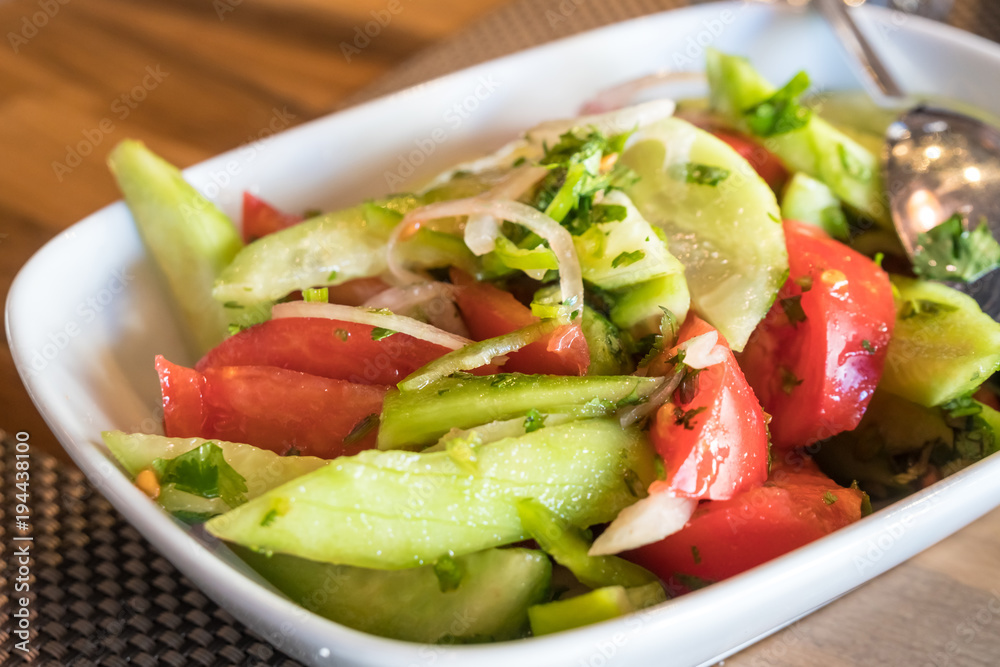 Tomato and cucumber salad with onion, pepper and parsly Tomato and cucumber salad with onion, pepper and parsly