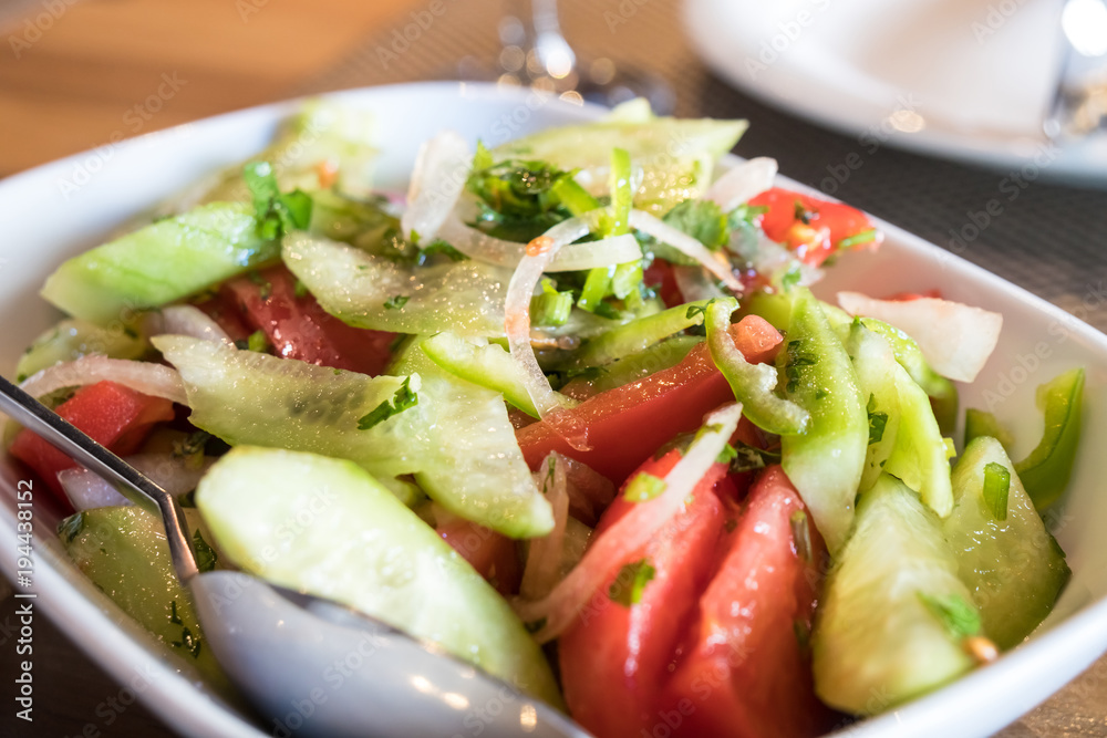 Tomato and cucumber salad with onion, pepper and parsly Tomato and cucumber salad with onion, pepper and parsly