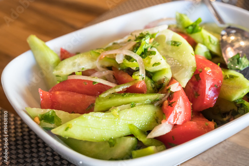 Tomato and cucumber salad with onion  pepper and parsly