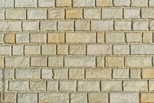 Yellow sandstone bricks wall background abstract texture.