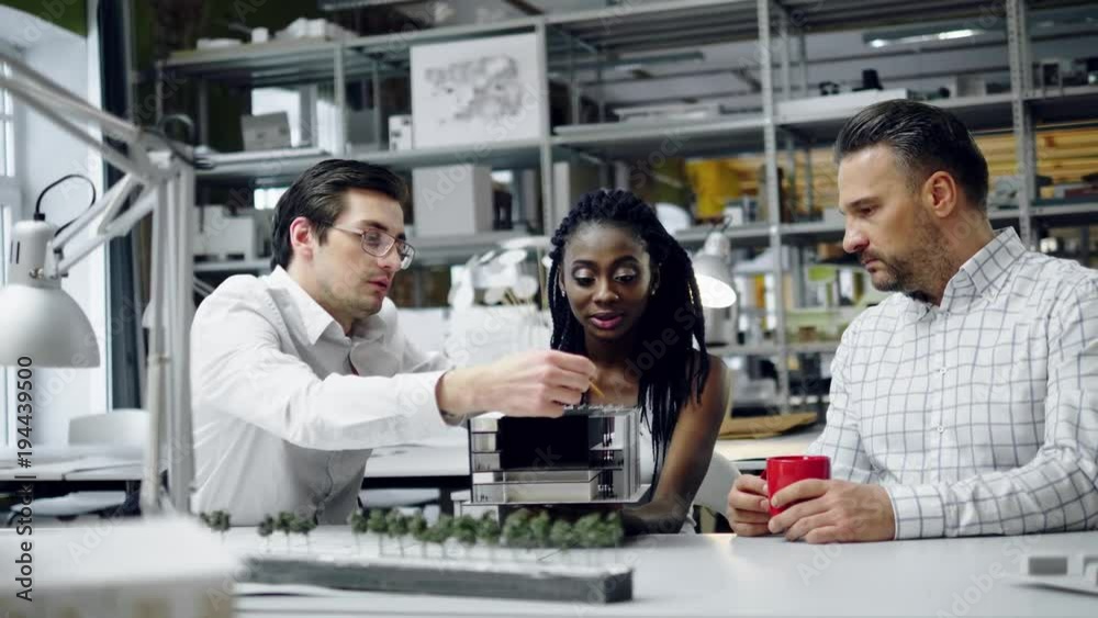 Multiracial team working in design and engineering architecture office.