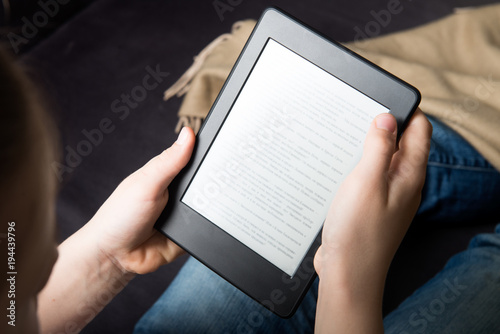 Girl is reading ebook on digital tablet device