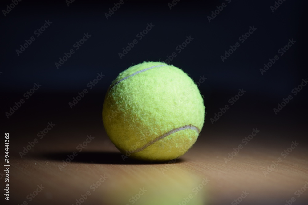 The ball is light green for a big tennis on the table.