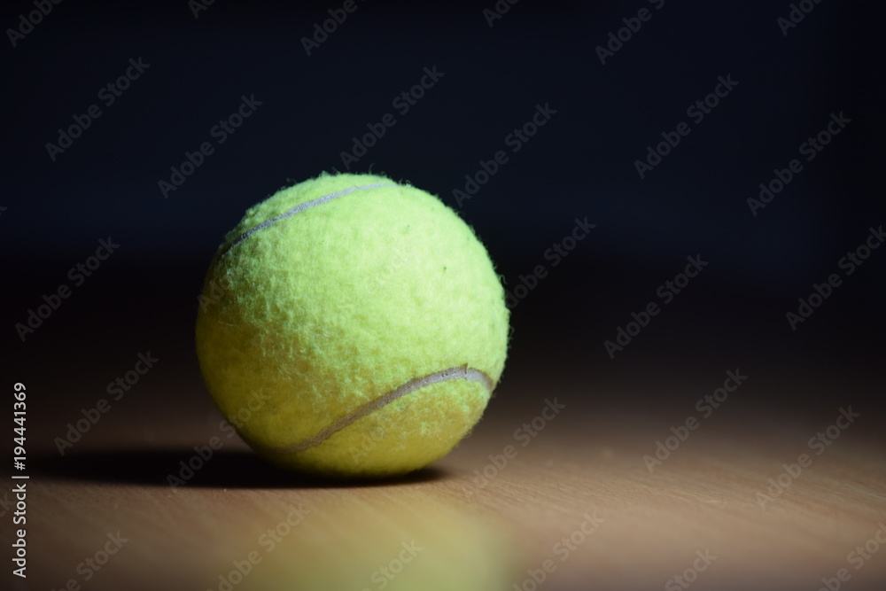 The ball is light green for a big tennis on the table.