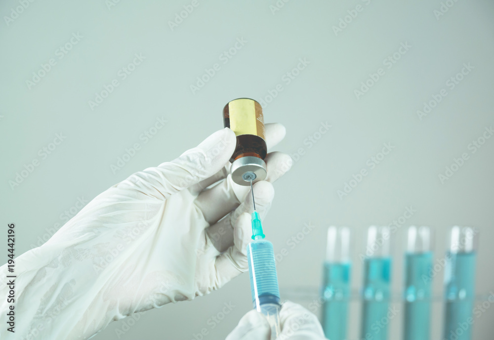 Researcher with glass laboratory chemical test tubes with liquid for analytical , medical, pharmaceutical and scientific research concept. Researcher with glass laboratory chemical test tubes with liquid for analytical , medical, pharmaceutical and scientific research concept.