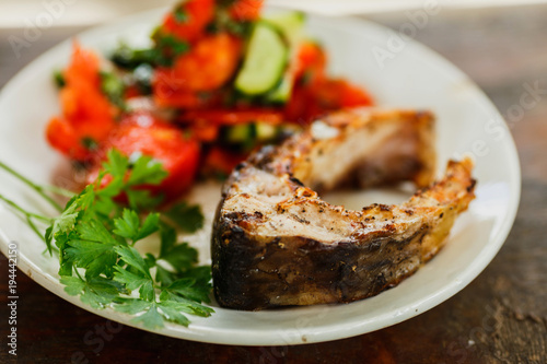 grilled piece of fish with vegetable salad, healthy meal, 