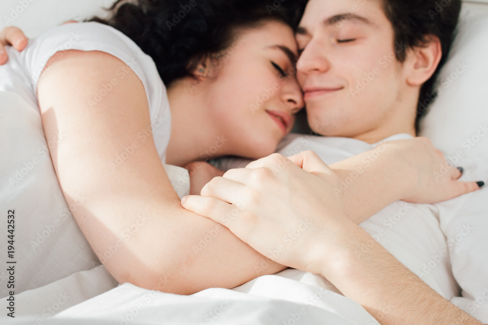 Couple in love sleeps cuddling in bed