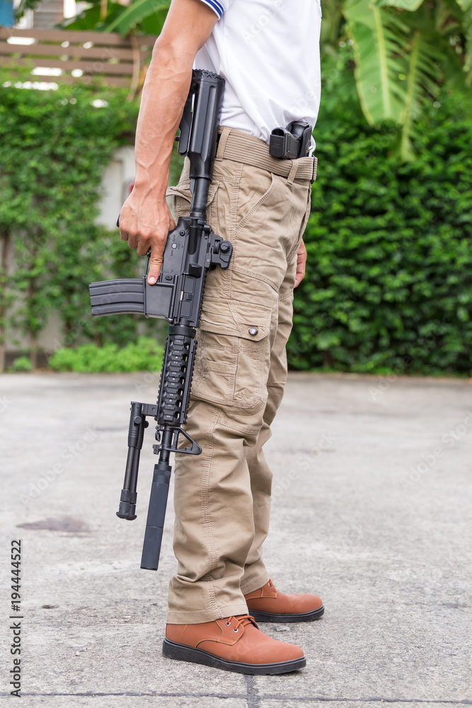Fototapeta premium man in cargo pants with gun