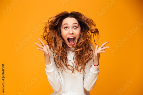 Screaming young woman standing isolated
