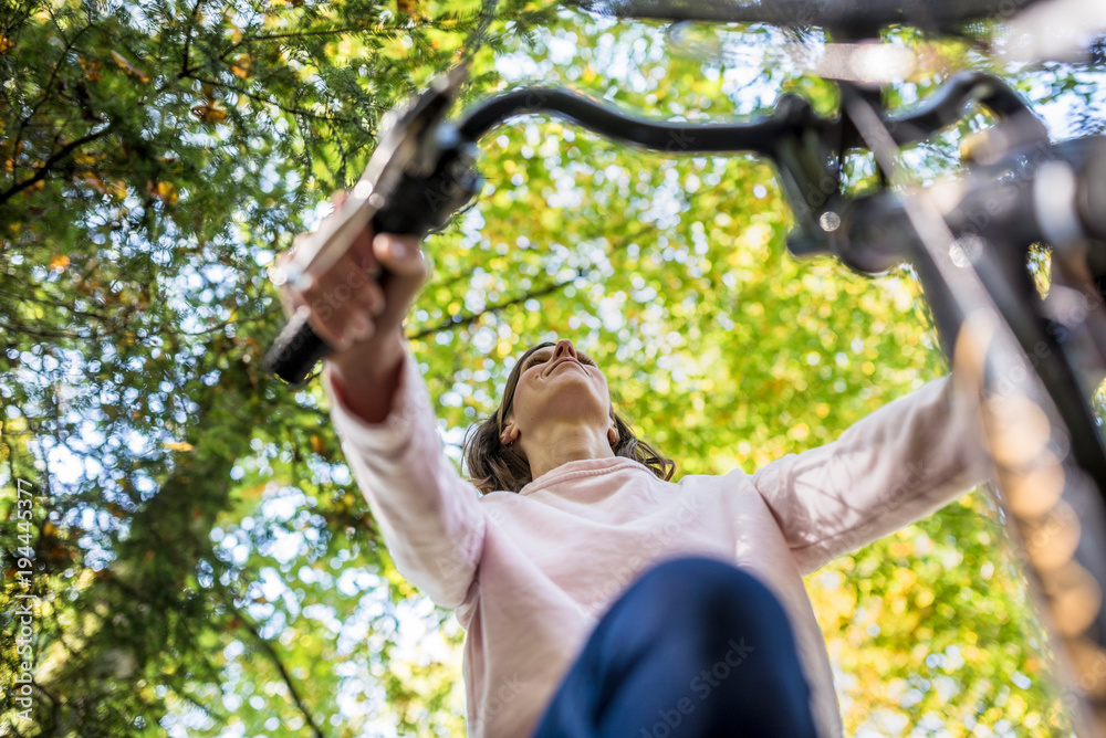 Woman riding a bicycle in autumn