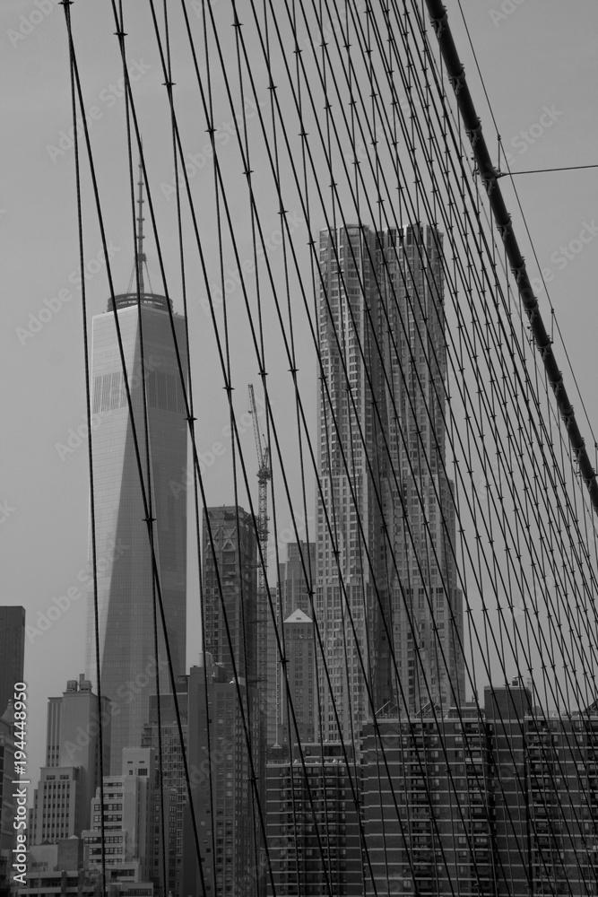 look at the wtc through ropes of the broolyn bridge