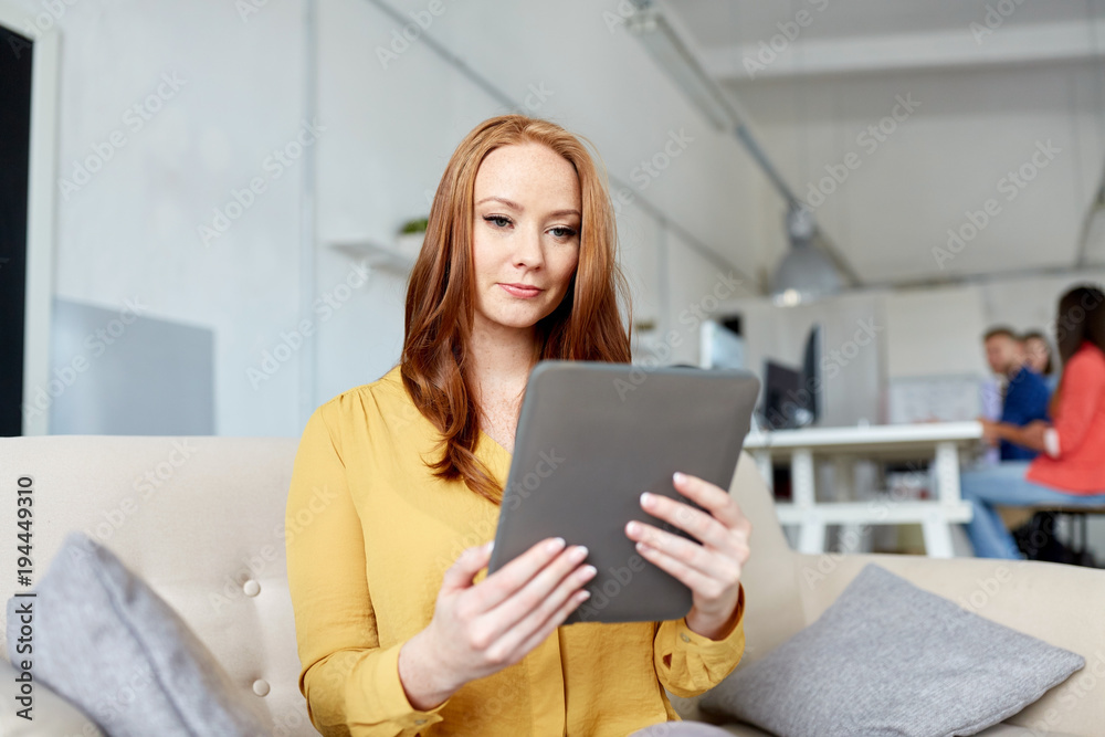 redhead woman with tablet pc working at office redhead woman with tablet pc working at office