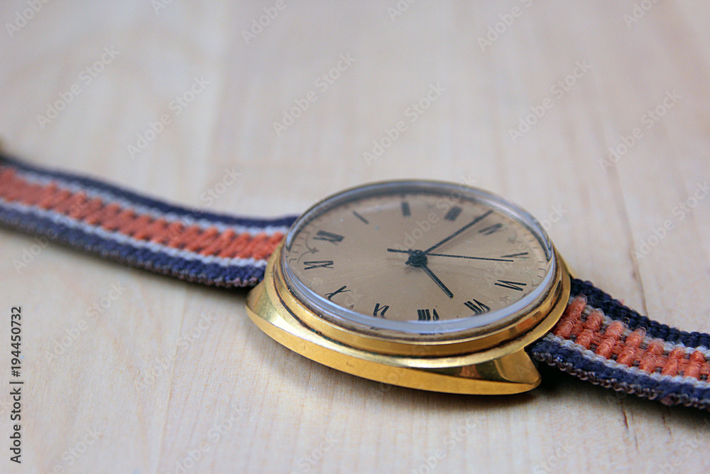 gold plated old shabby soviet watch closeup on wooden table gold plated old shabby soviet watch closeup on wooden table