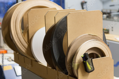Fotografie veneer or edge band tapes at woodworking factory
