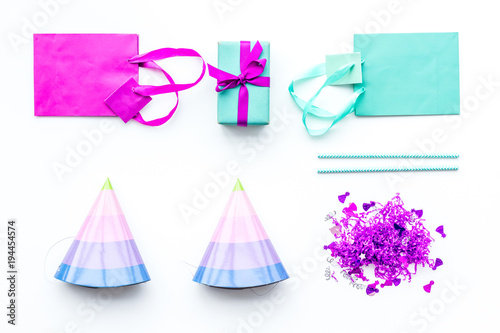 Birthday party accessories. Gift box, paper bag, party hat, confetti on white background top view copy space © 9dreamstudio