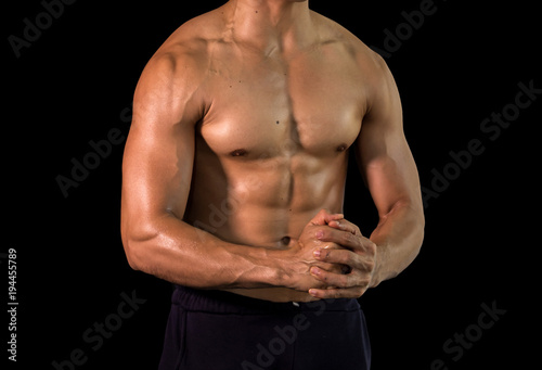 Close up bodybuilder muscular beautiful body on black background