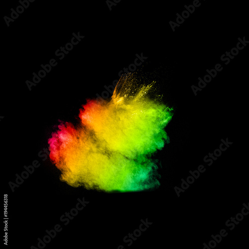 Multicolored powder explosion cloud isolated on black background. Freeze motion of color dust particles splash.