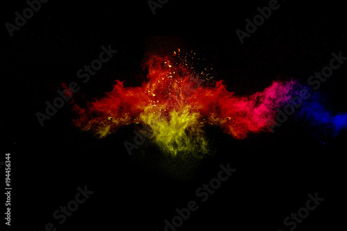 Multicolored powder explosion cloud isolated on black background. Freeze motion of color dust particles splash.