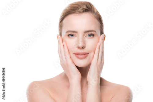 Woman with fresh clean skin touching own face isolated on white