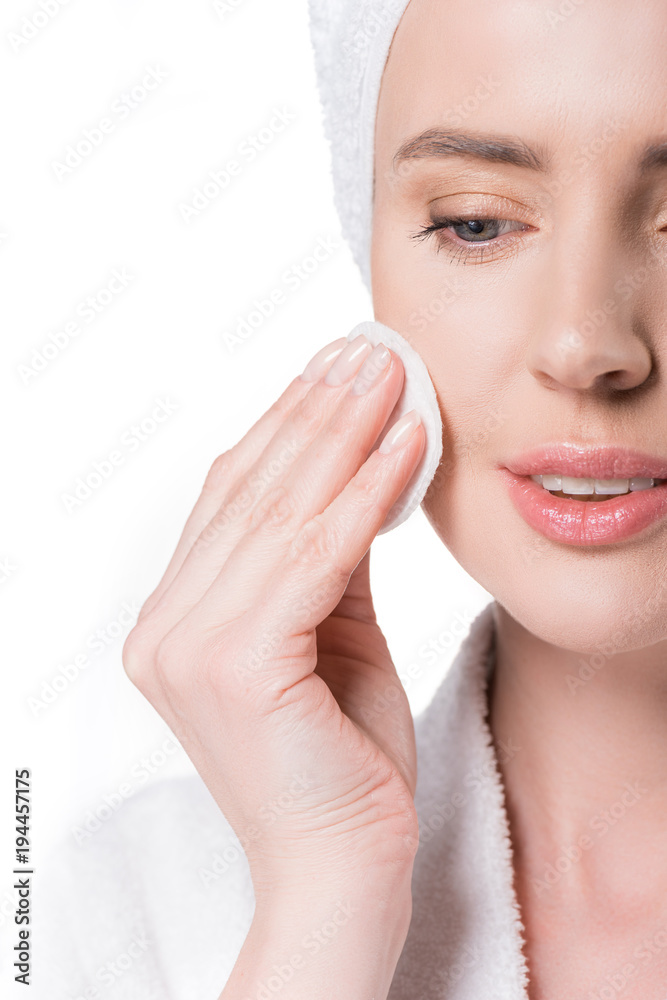 Cropped view of woman using cotton pad isolated on white Cropped view of woman using cotton pad isolated on white