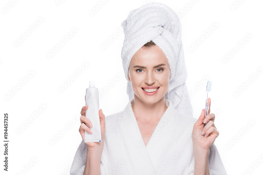 Woman with clean skin holding tootbrush and toothpaste isolated on white Woman with clean skin holding tootbrush and toothpaste isolated on white