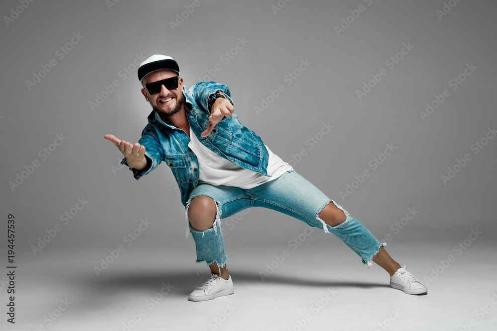 man in a cap and jeans suit on a gray background in the studio
man in a cap and jeans suit on a gray background in the studio