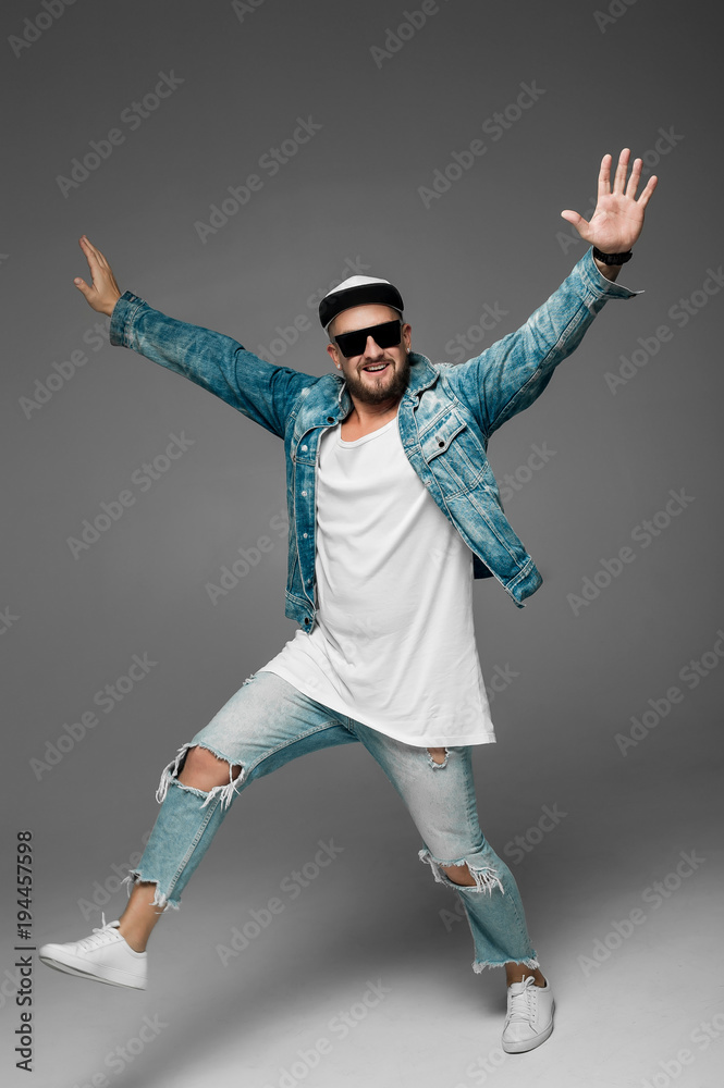 man in a cap and jeans suit on a gray background in the studio
man in a cap and jeans suit on a gray background in the studio