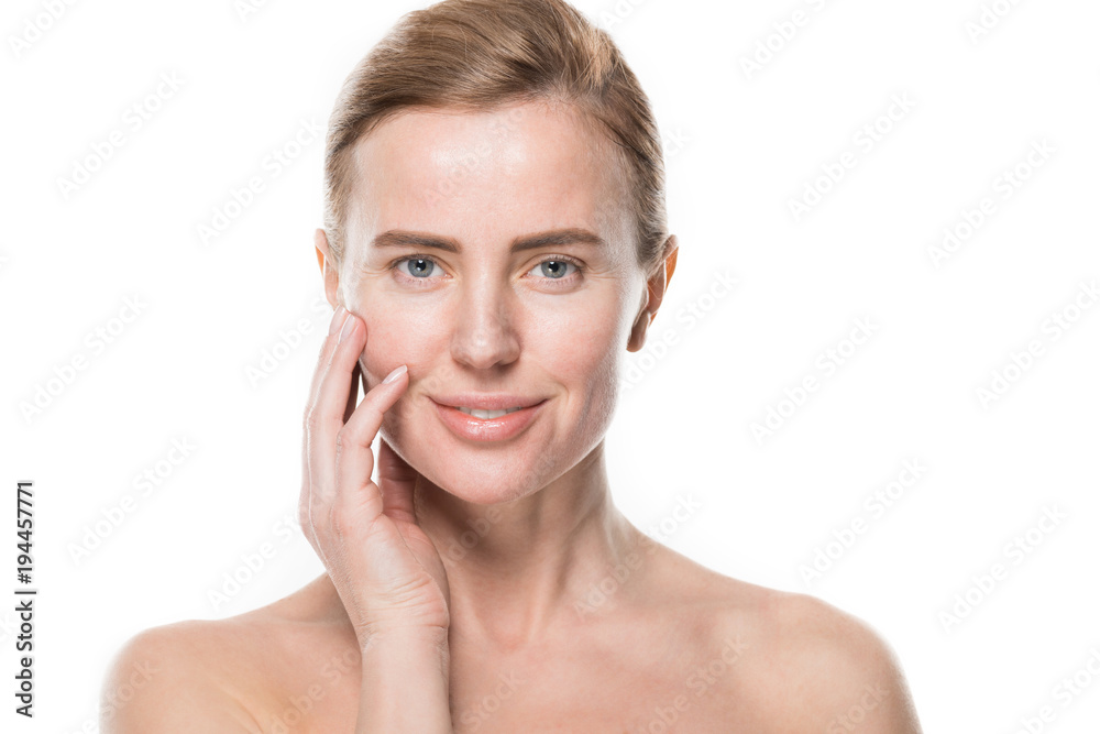 Woman with clean fresh skin touching own face isolated on white