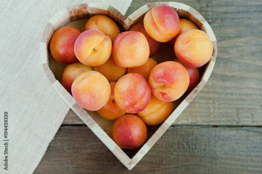Peaches ripe fresh healthy fruit in a heart shaped bowl Peaches ripe fresh healthy fruit in a heart shaped bowl