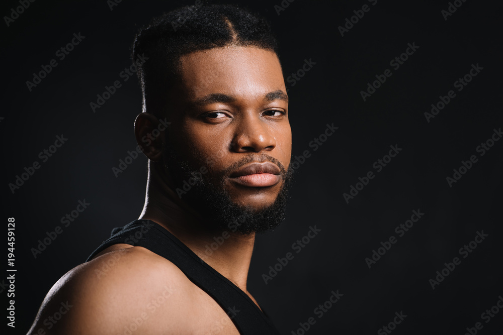portrait of handsome young athletic african american man looking at camera isolated on black portrait of handsome young athletic african american man looking at camera isolated on black