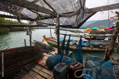 Fishing tackle on Pier made of wooden planks in the fishing village on Ko Chang island, Thailand.