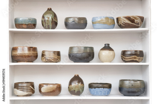 Ceramic container / View of ceramic container on wooden shelf. Fototapet
