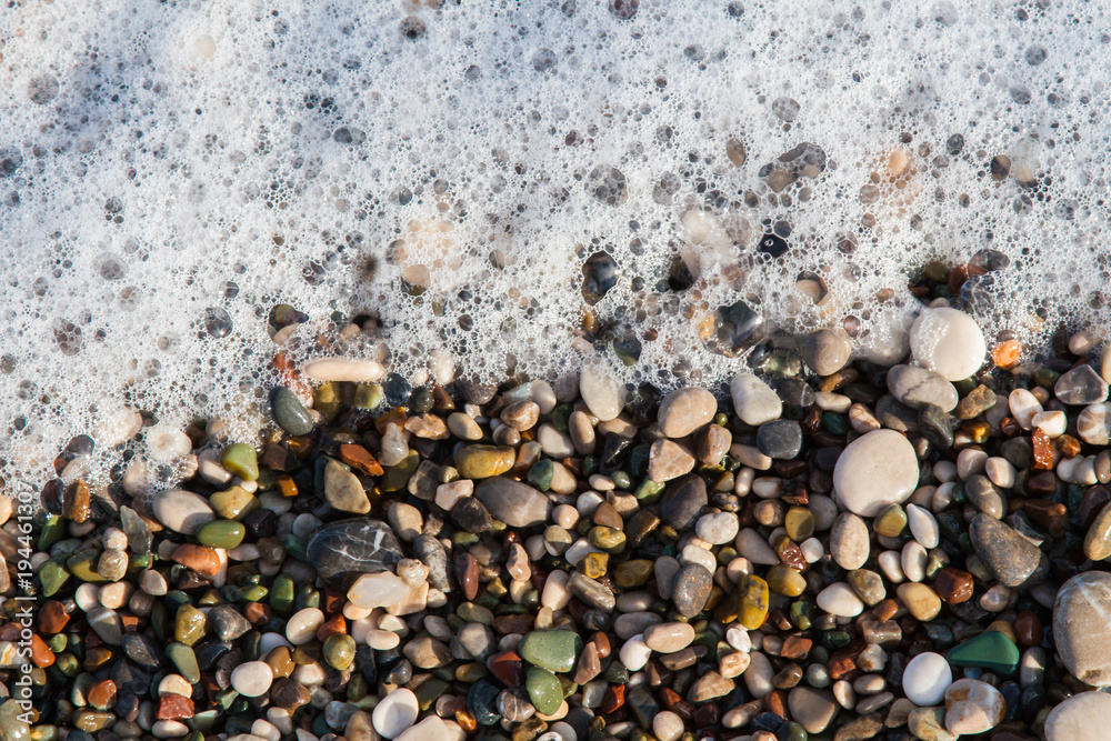 multi-colored pebbles on the beach, washed by waves multi-colored pebbles on the beach, washed by waves
