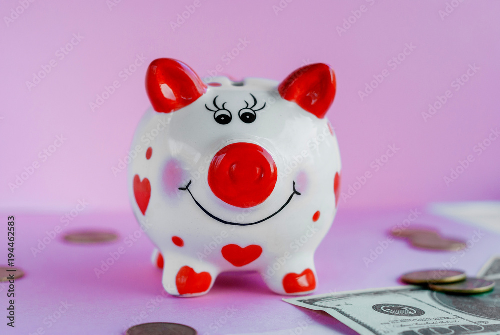 Savings concept. Funny piggy bank and on pink background Savings concept. Funny piggy bank and on pink background