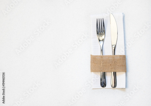 white napkin, knife and fork, place for dinner served in rustic style