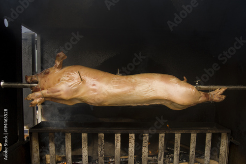 Baking a piglet on fire. Piglet on the roasting-jack