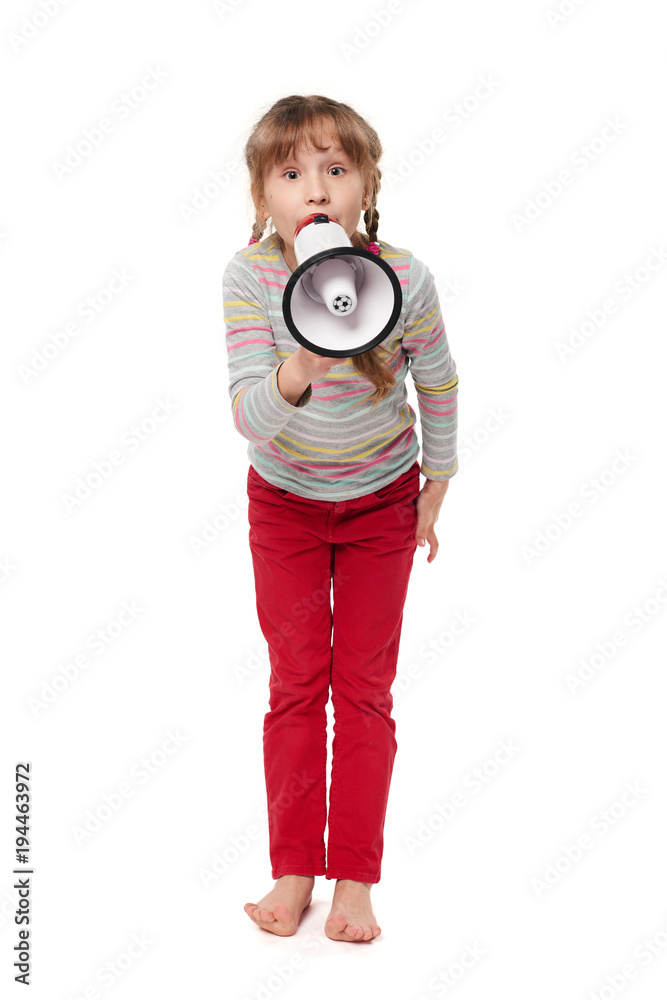 Fototapeta premium Full length happy little girl screaming in loudspeaker, over white background