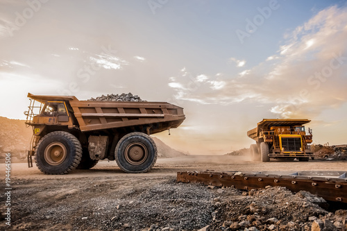 Fototapeta Mining dump trucks transporting Platinum ore for processing