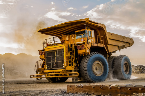 Fototapeta Mining dump trucks transporting Platinum ore for processing