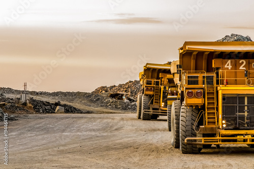 Mining dump trucks transporting Platinum ore for processing photo