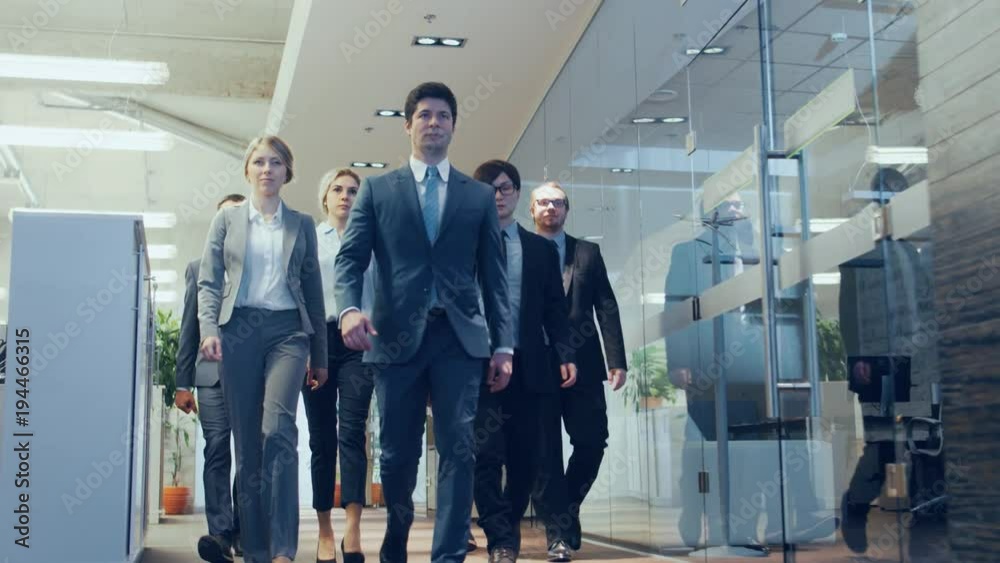 Diverse Team of Delegates/ Lawyers Confidently Marching Through the Corporate Building Hallway. Multicultural Crowd Of Resolute Business People in Stylish Marble and Glass Offices. Diverse Team of Delegates/ Lawyers Confidently Marching Through the Corporate Building Hallway. Multicultural Crowd Of Resolute Business People in Stylish Marble and Glass Offices.