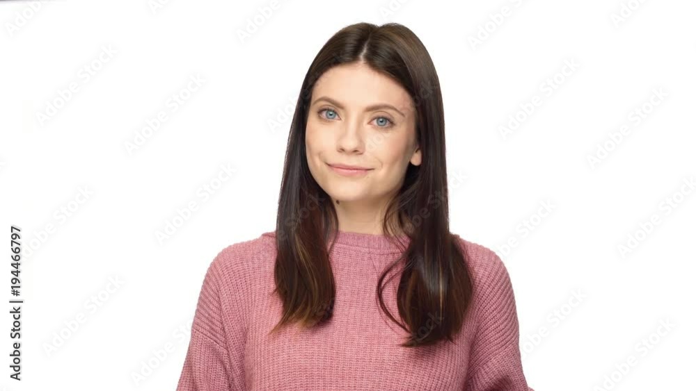 Portrait of charming adult woman 30s looking at camera with candid smile, isolated over white background in studio. Concept of emotions Portrait of charming adult woman 30s looking at camera with candid smile, isolated over white background in studio. Concept of emotions